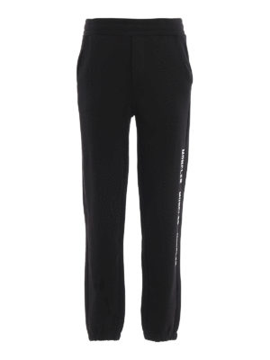 MONCLER: tracksuit bottoms - Repeated logo print cotton joggers