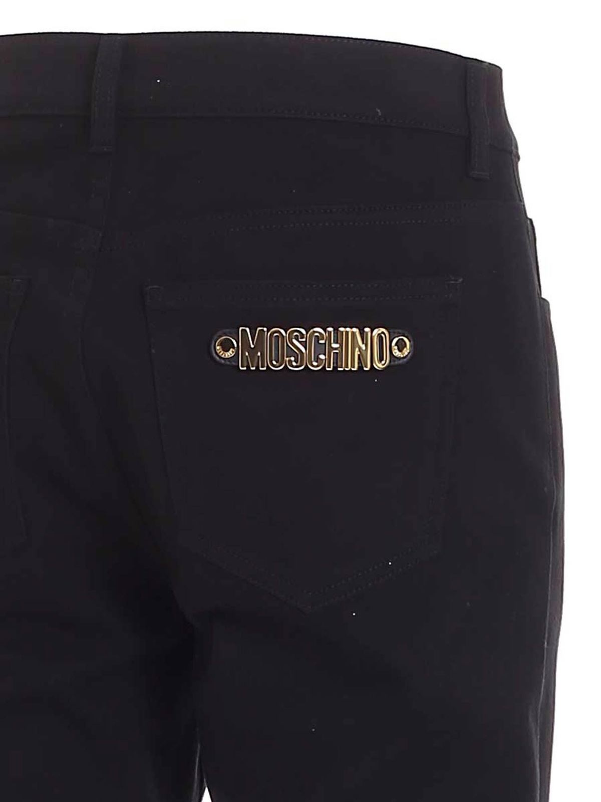 Golden metal logo pants in black 