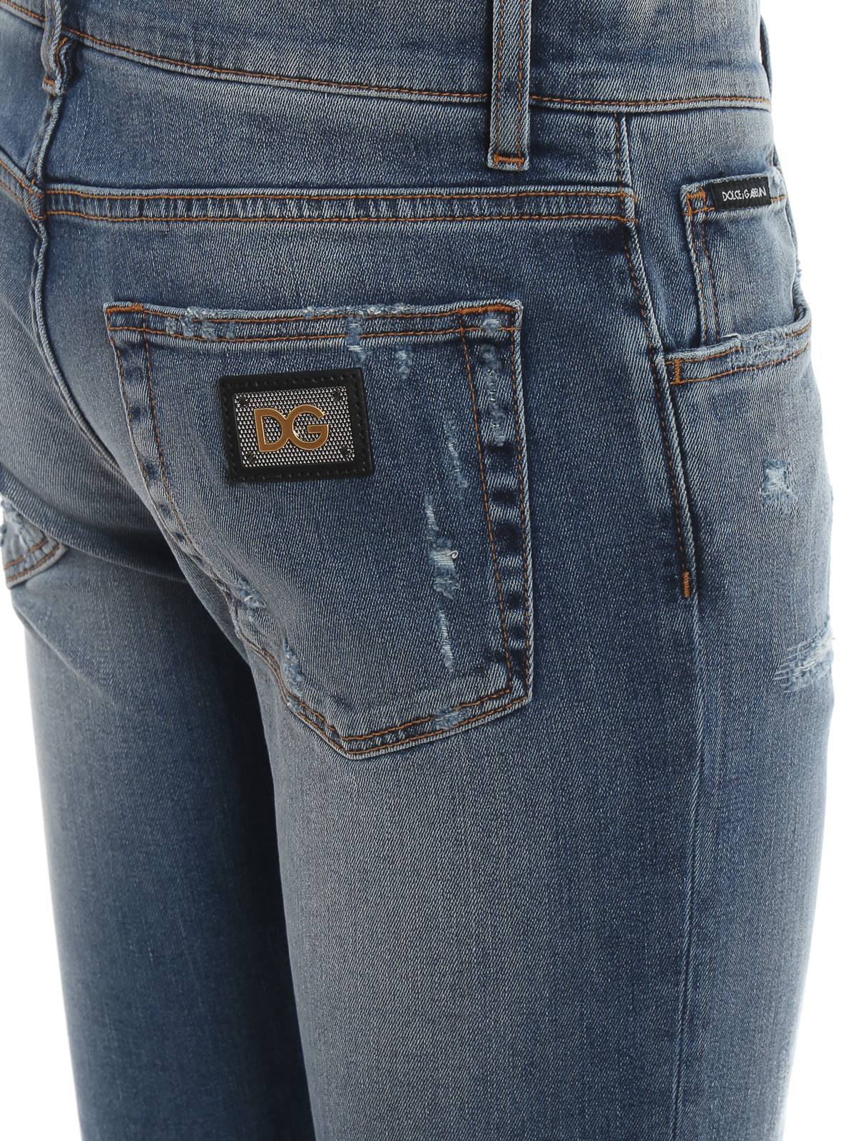 Distressed denim five pocket jeans 