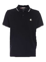 Polo in pique nero con profili a contrasto